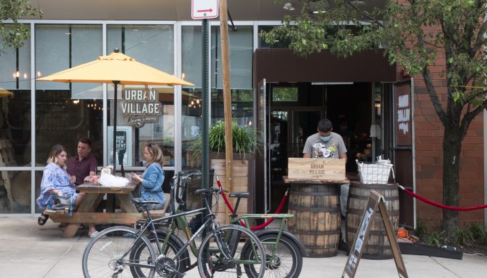 people dining outdoors at a pinic table outside a restaurant