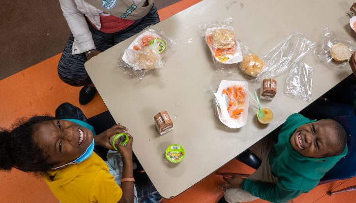 Children enjoying a free meal at a rec center