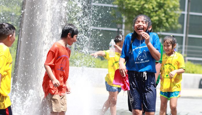 Kids playing in the sprinklers at Dilworth Park.