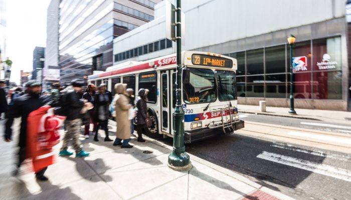 People getting on SEPTA bus in Philadelphia during the day.