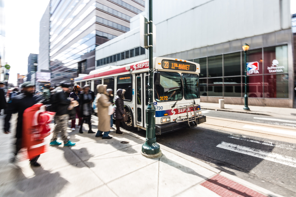 People getting on SEPTA bus in Philadelphia during the day.