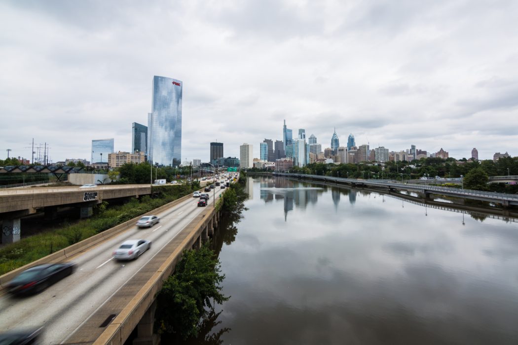 the philadelphia city skyline with a river in the foreground