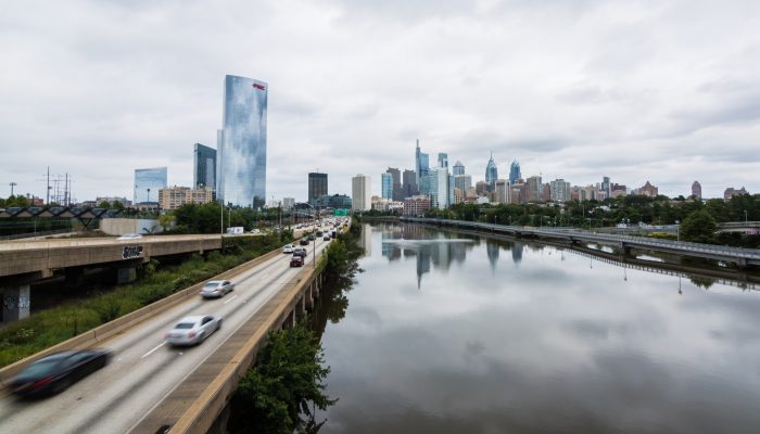 the philadelphia city skyline with a river in the foreground