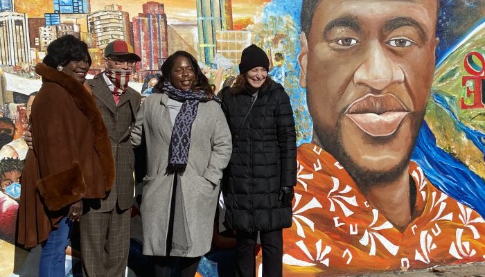 people in front of mural tribute