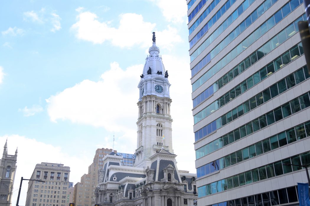 View of City Hall from the ground during the day. A blue sky is in the background.