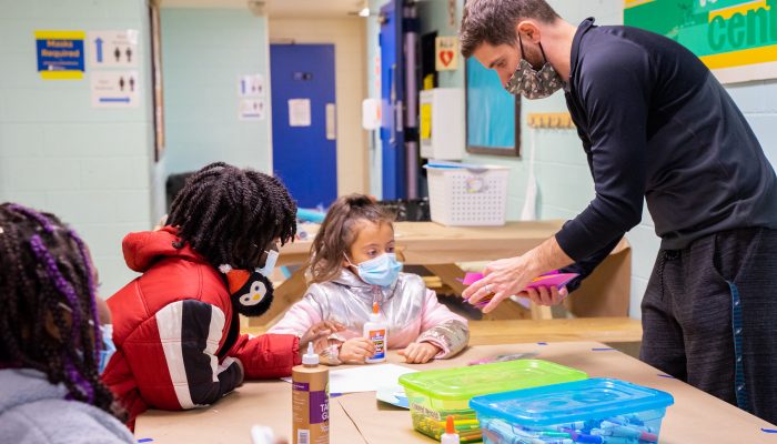 PPR staff member helping kids at a rec center.