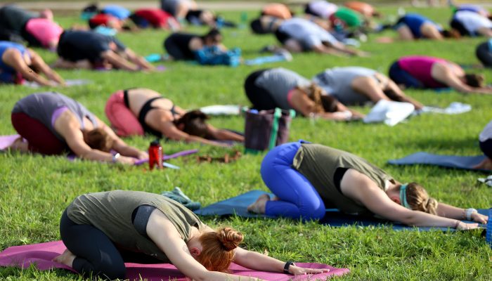 People in the park following a yoga lesson.