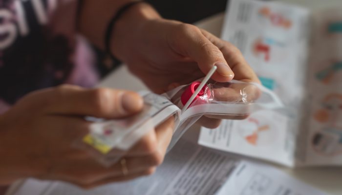 Person opening an at-home COVID test