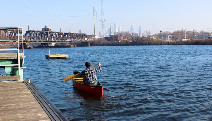 Man taking his canoe out onto the Schuylkill River.