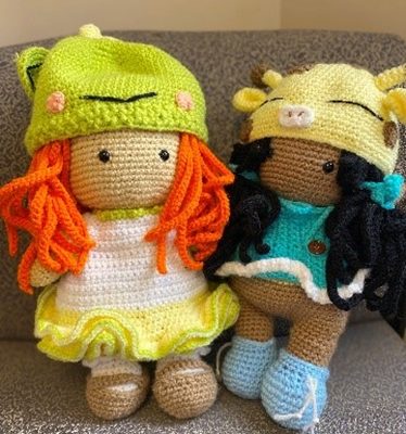 Two crocheted dolls that are ready to be gifted.