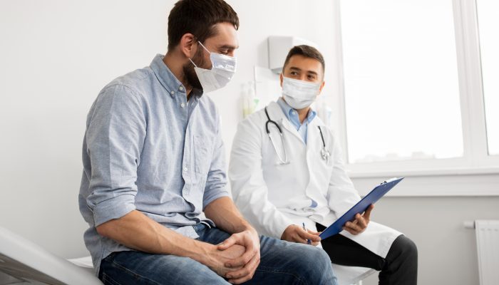 Man talking with his healthcare provider in a medical office