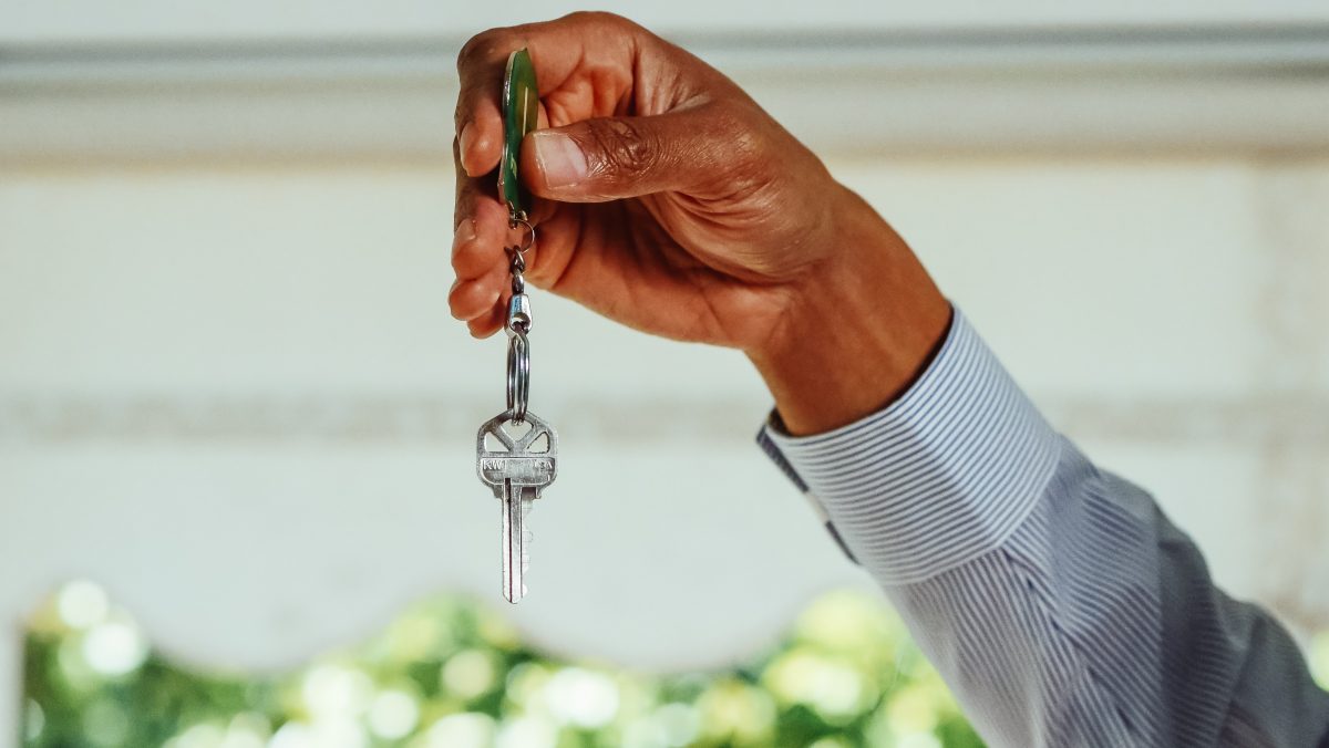 A person holding a silver key