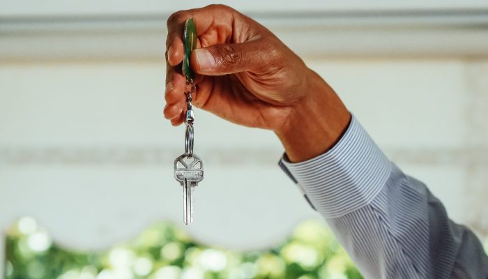 A person holding a silver key