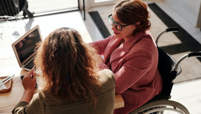 A person in a wheelchair talks with another person