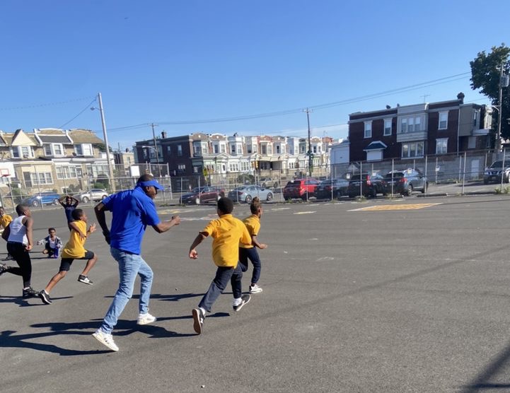Man and Children running in school yard