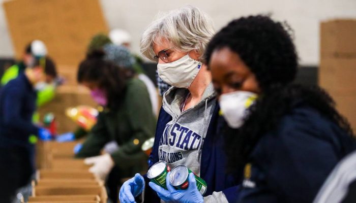 Two women volunteers pack food boxes to help feed hungry Philadelphians