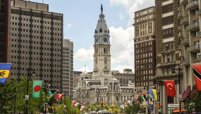 flags along the ben franklin parkway with city hall in the background as the focal point