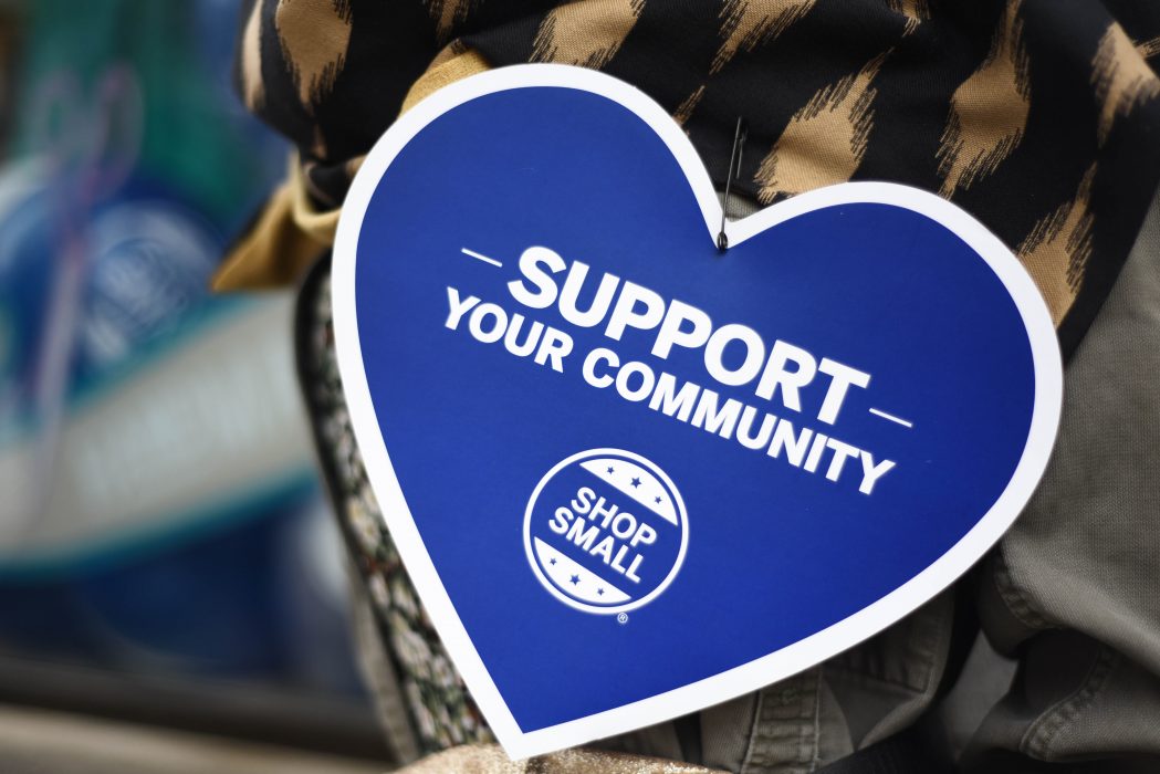 Heart shaped that reads "support your community shop small"