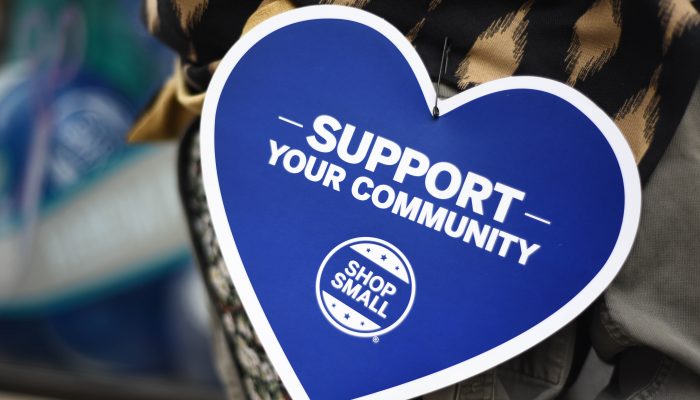 Heart shaped that reads "support your community shop small"