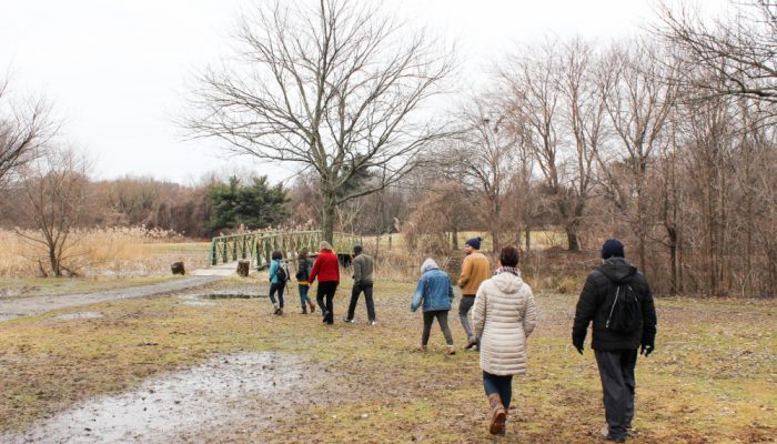 People bundled up in winter coats walking in FDR park.