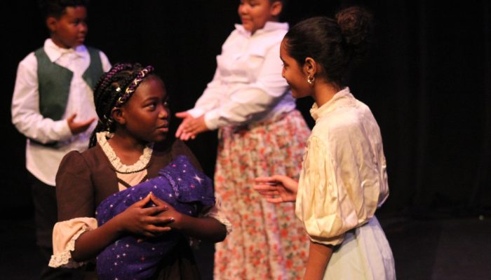 African-American kids acting in a production.