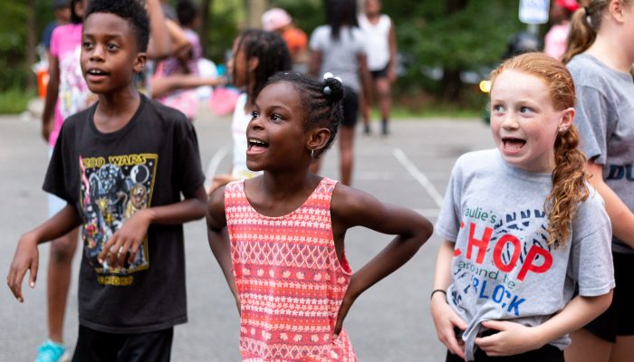 Kids laughing and playing at summer camp.