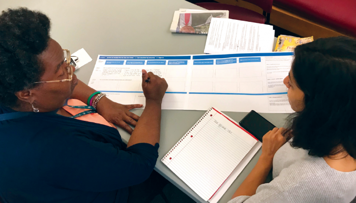 Image of two women discussing a document