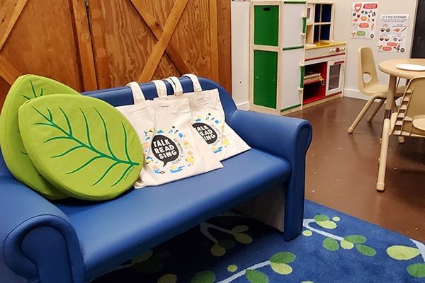 A rug and couch in a children's reading room