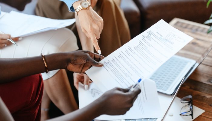 people pointing to paperwork