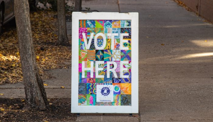 Signage on the ground that says, vote here.