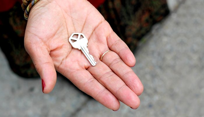An open hand holding a key