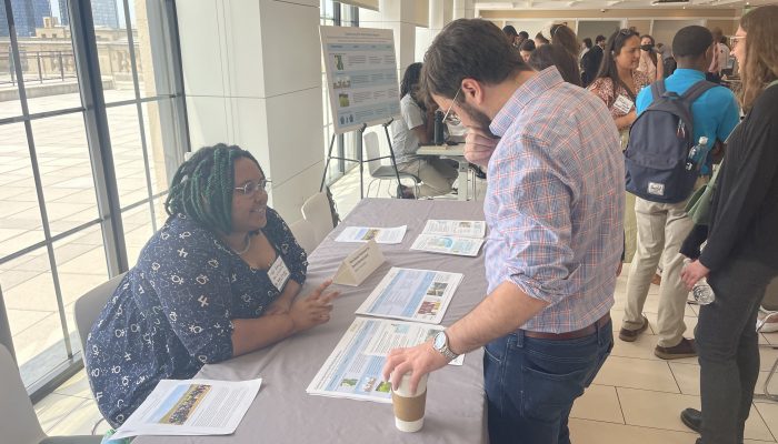 Equipes de projeto explicam materiais para convidados no OTF Showcase