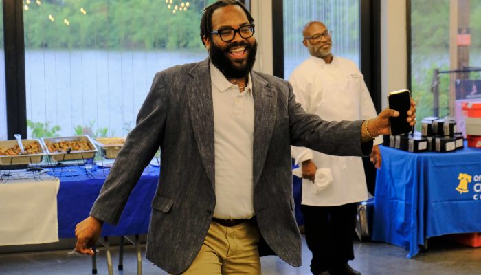 An attendee of the Community School Awards dances on the dance floor, celebrating the fun times had.