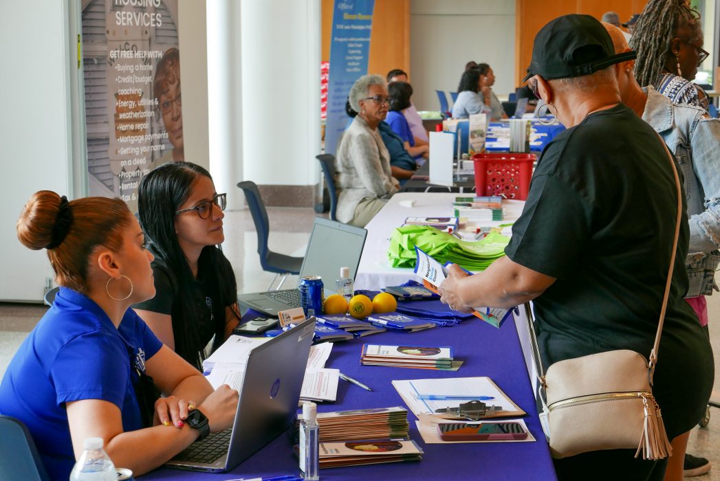 Residents explore the Energy Coordinating Agency's table at the North Philly energy fair in April 2023.