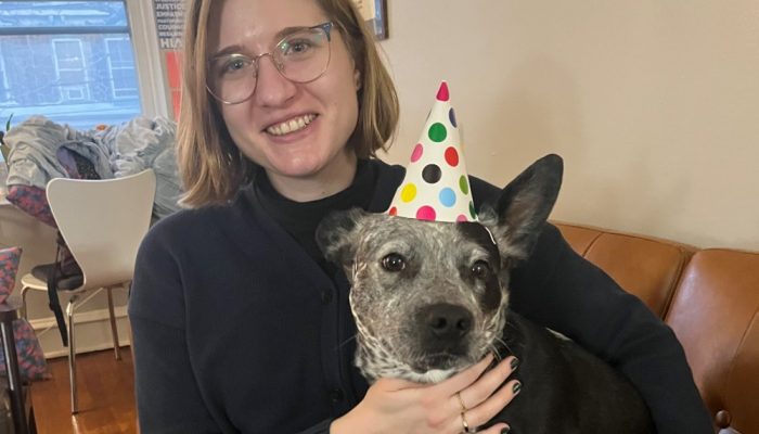 Office of Immigrant Affairs Staffer with puppy with birthday hat
