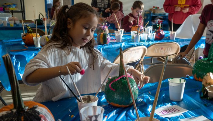 A elementary school girl decorates her pumpkin at Kendrick Recreation Center in Philadelphia.