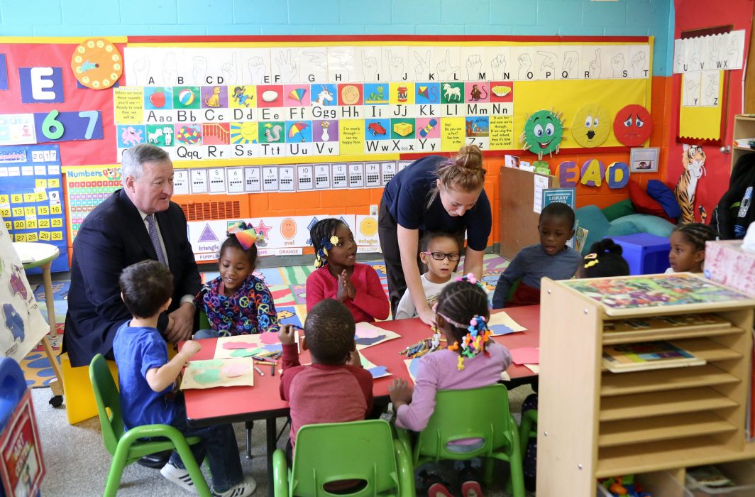 PHLpreK students seated at a table with Mayor Jim Kenney and a teacher