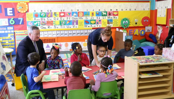 PHLpreK students seated at a table with Mayor Jim Kenney and a teacher