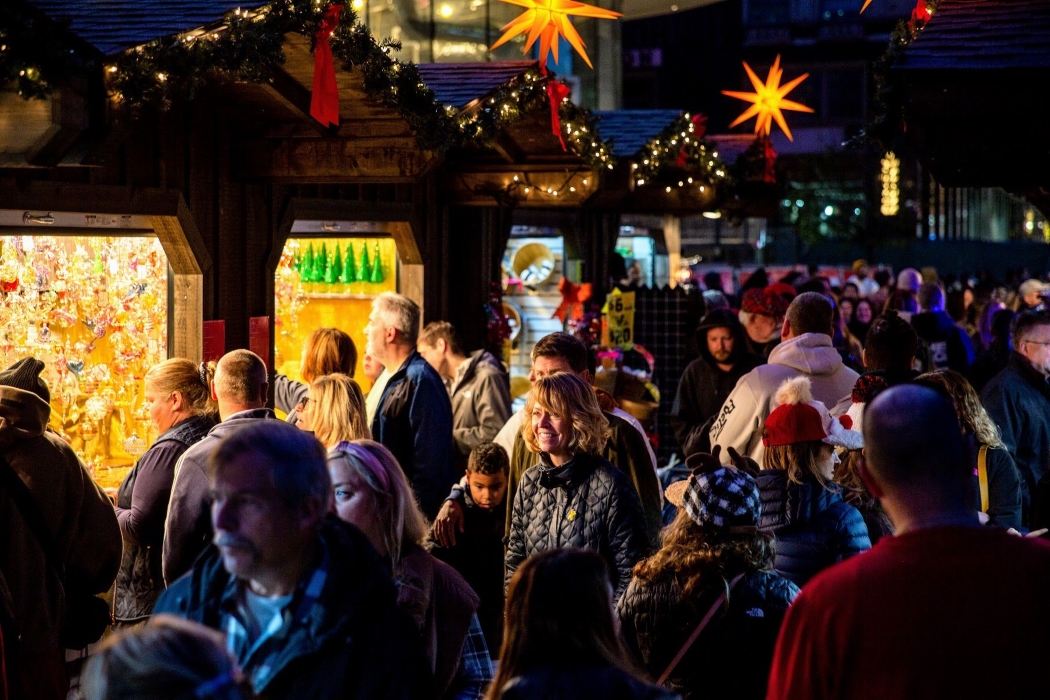Visitors shop in Christmas Village at night in LOVE Park. Christmas Village is an open-air German Christmas Market that features over 120 local and international vendors.
