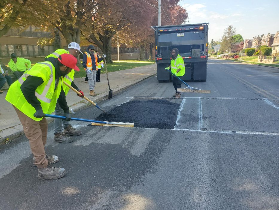 Streets employees installing speed cushion