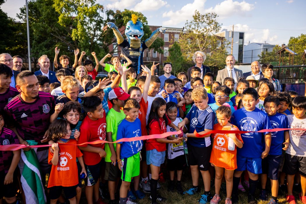 Mayor Kenney, Phang, and community members cut a ribbon for Capitolo Playground