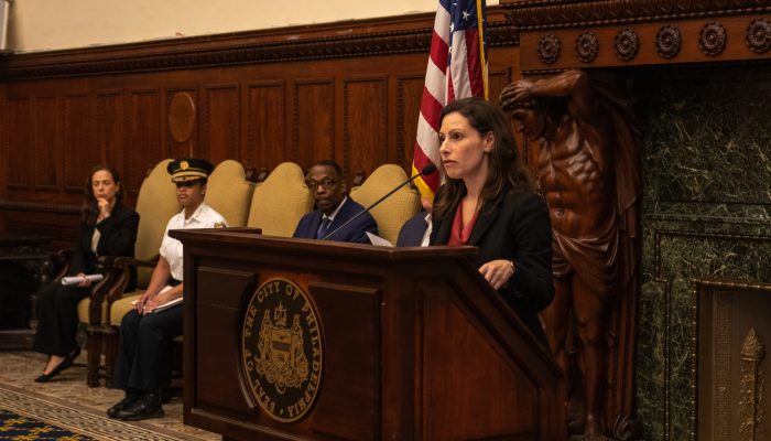 Renee Garcia stands at the podium of a press conference