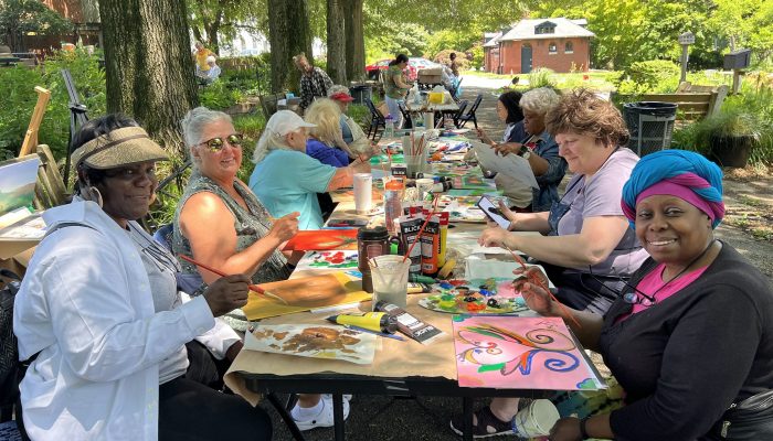 Older Adults paint outside at the Fairmount Horticulture Center. The event was part of Philadelphia Parks & Recreation's senior art camp.