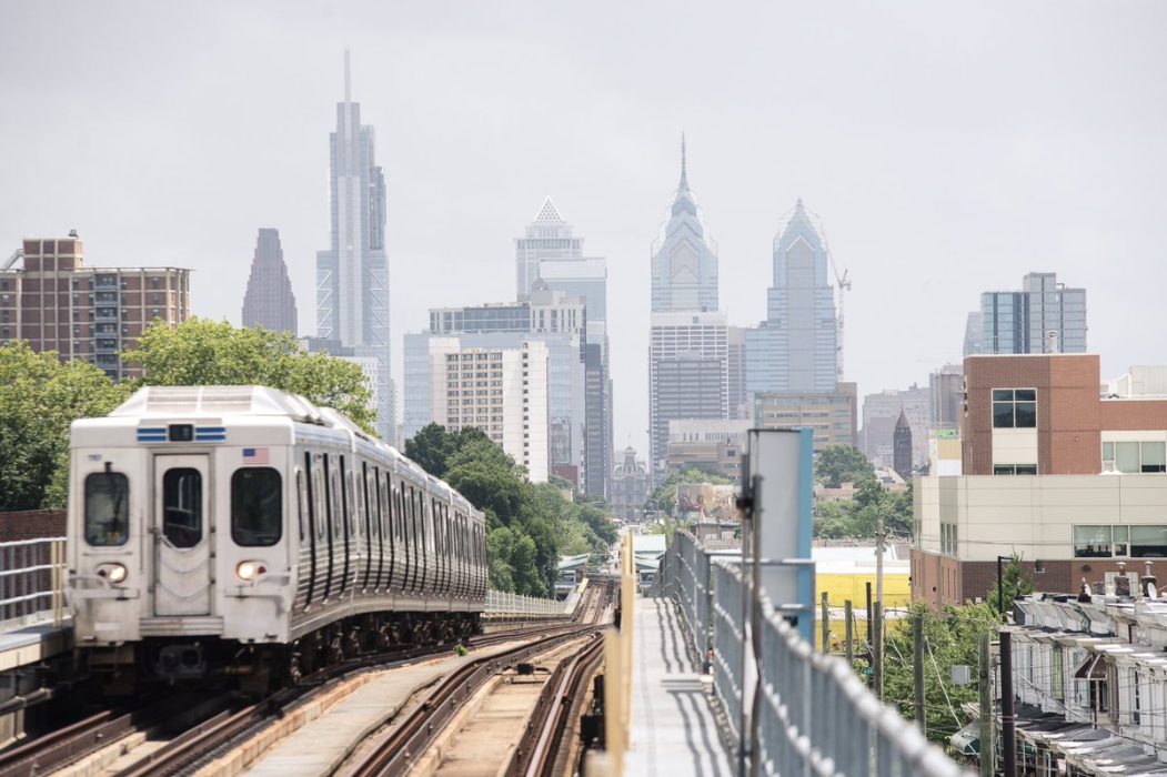 A train passes by the city skyline
