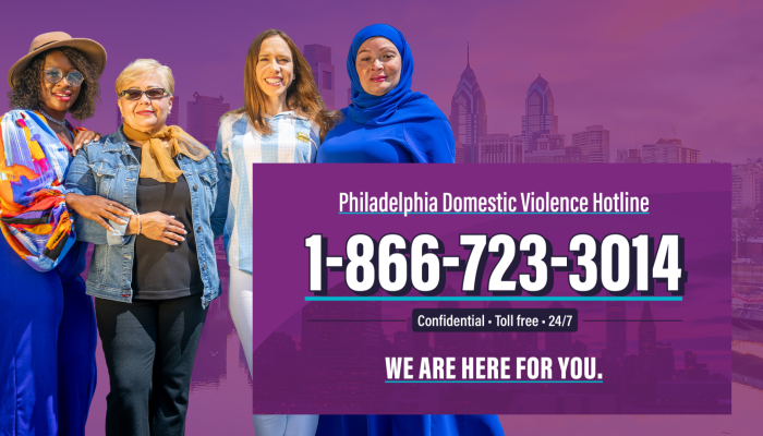 Four women stand together in front of a purple Philadelphia Skyline. Next to them, text reads: Philadelphia Domestic Violence Hotline, 1-866-723-3014. Confidential, toll free, 24/7. We are here for you.