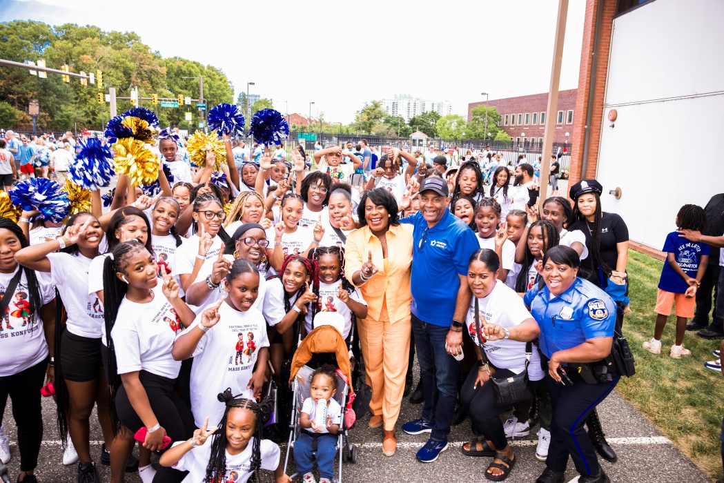 Mayor Cherelle L. Parker smiling with a large group at a Labor Day Parade