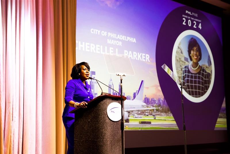Mayor Cherelle L. Parker speaking behind a podium at the PHL International Airport’s “State of the Airport” meeting at the Pennsylvania Convention Center