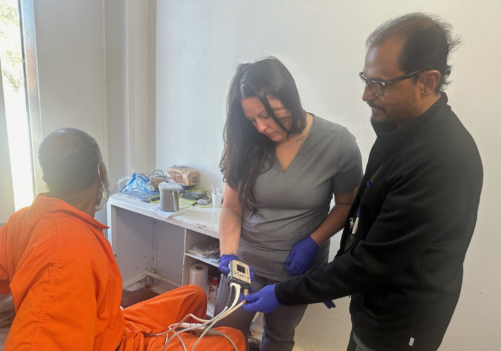 A medical student examining and providing medical services to an inmate.