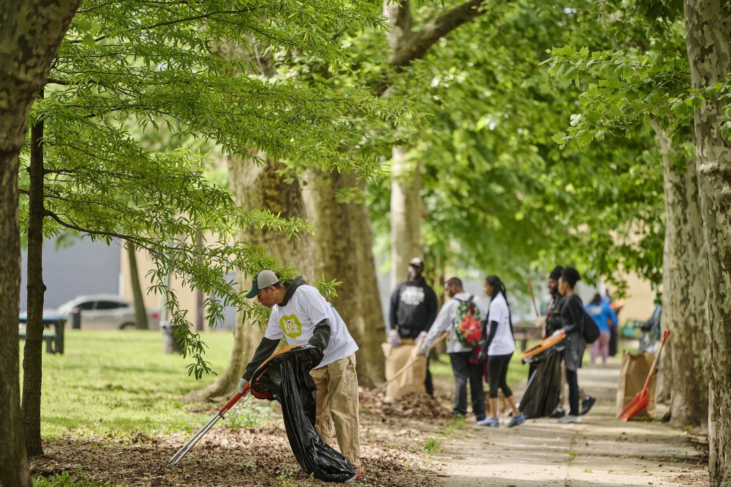Volunteers clean up leaves in Stinger Square.