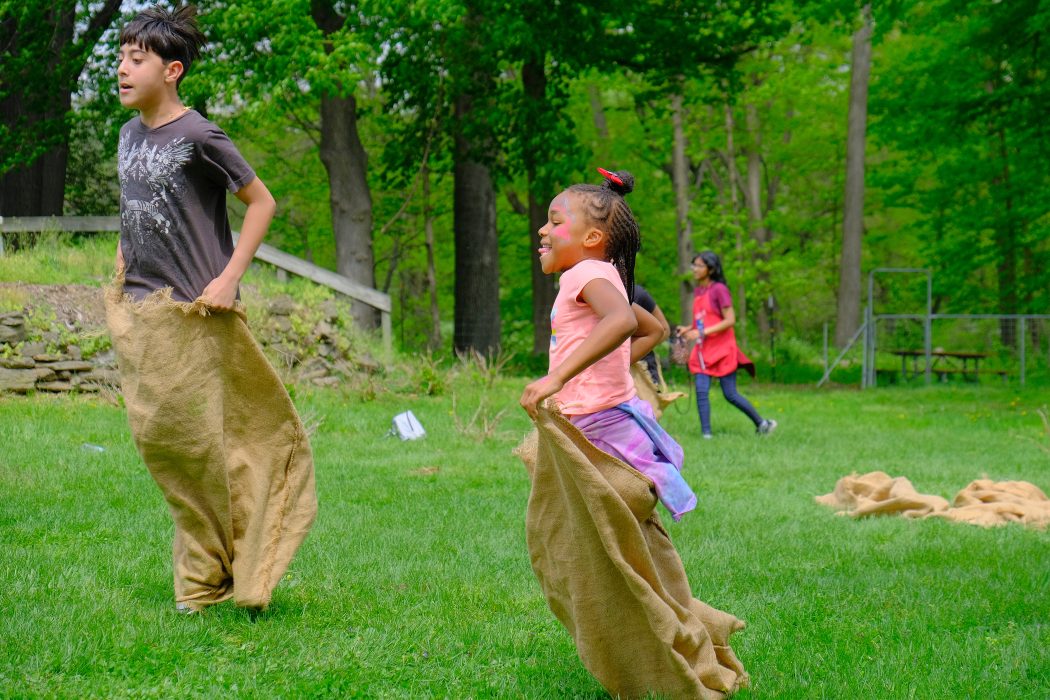 Young people enjoy a hacky sack race in a Philly park.